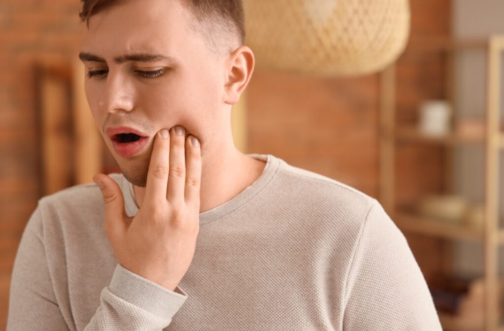 A person holding their jaw from pain