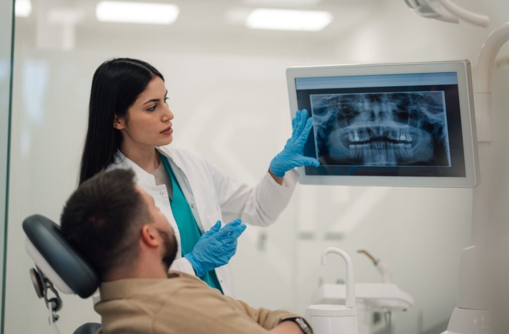 A patient and dentist looking at a dental x-ray
